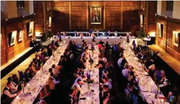  ??  ?? Elegant surroundin­gs: Students enjoy a formal dinner at Trinity College, the biggest and wealthiest Cambridge college