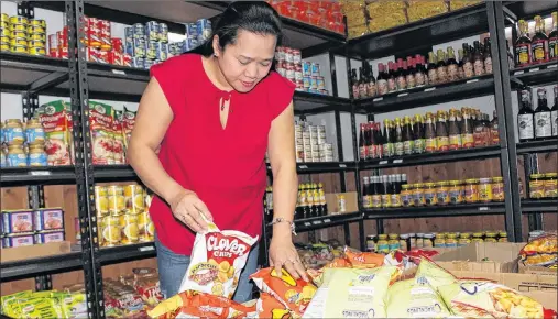  ?? MILLICENT MCKAY/JOURNAL PIONEER ?? Leilani Cornejo Gallant stocks boxes of chips in her 2 Brothers Asian Store located in Summerside.