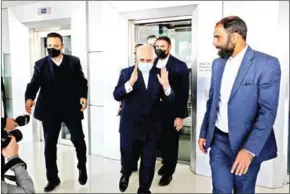  ?? AFP ?? Iranian Minister of Foreign Affairs Mohammad Javad Zarif (centre) greets journalist­s following the Internatio­nal Conference on the Legal-Internatio­nal Claims of the Holy Defense in the capital Tehran on Tuesday.