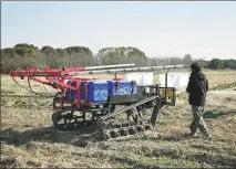  ?? ZHAO YIHE / XINHUA ?? An engineer maneuvers a farm robot in a field at the Diantian Farm in Shanghai on Jan 25.