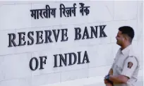  ??  ?? MUMBAI: An Indian policeman walks through the Reserve Bank of India (RBI) head office in Mumbai yesterday. —AFP