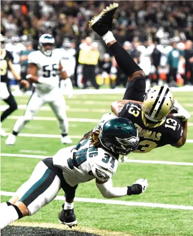  ?? Bill Feig/Associated Press ?? ■ New Orleans Saints wide receiver Michael Thomas (13) pulls in a touchdown reception against Philadelph­ia Eagles cornerback Cre'von LeBlanc (34) in the second half Sunday in New Orleans. The Saints defeated the Eagles, 20-14.