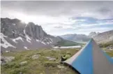  ??  ?? A National Outdoor Leadership School student spends time relaxing by their tent in the Wind River Range of Wyoming.