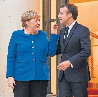  ?? Picture: Getty Images. ?? Mrs Merkel and Mr Macron in animated conversati­on.