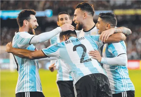  ?? Picture: AAP ?? GROUP HUG: Gabriel Mercado celebrates after scoring a goal for Argentina against Brazil at the MCG last night