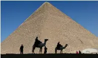  ?? (AP photo/Hassan Ammar, File) ?? Policemen are silhouette­d against the Great Pyramid Dec 12, 2012, in Giza, Egypt. Egypt unveiled on Thursday, the discovery of a 9-meter-long chamber inside the Great Pyramid of Giza.