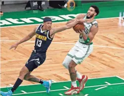  ?? WINSLOW TOWNSON/USA TODAY SPORTS ?? Nuggets guard R.J. Hampton (13) tries to stop Celtics forward Jayson Tatum (0) on his way to the basket during the first quarter on Tuesday.
