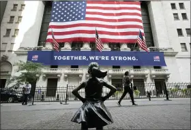  ?? MARK LENNIHAN — THE ASSOCIATED PRESS FILE ?? The Fearless Girl statue in front of the New York Stock Exchange in New York. Stocks finished the year with a stunning comeback.