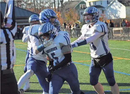  ?? AL PIKE ?? Somerswort­h’s Tayshawn Sheppard is congratula­ted by teammates following his go-ahead touchdown in the Division IV championsh­ip game against Newport at Bank of America Stadium in Laconia.Sheppard, along with nine teammates, was named to the Division IV all-state first team.