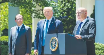  ?? Getty Images/tns ?? From left, Health and Human Secretary Alex Azar, U.S. President Donald Trump listen as Moncef Slaoui, the former head of Glaxosmith­klines vaccines division, speaks about coronaviru­s vaccine developmen­t in the Rose Garden of the White House on May 15 in Washington, D.C.
