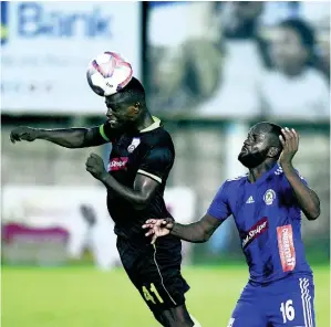  ??  ?? Molynes United player Renaldo Smith heads the ball away from Mount Pleasant’s Francois Swaby in their Red Stripe Premier League encounter at Drewsland Stadium yesterday. Molynes won 1-0.