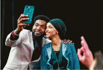  ?? Kerem Yucel / AFP/Getty Images ?? Ilhan Omar, newly elected to the U.S. House, celebrates with her supporters in Minneapoli­s. Voters elected two Muslim women, both Democrats, to Congress, marking a historic first.