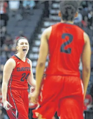  ?? DAVID JABLONSKI / STAFF ?? Andrea Hoover celebrates a basket during a Sweet 16 victory over Louisville at the Times Union Center. Hoover’s 26 points led the Flyers, who advanced to the Elite Eight for the first time.