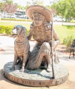  ?? RICK KILBY ?? John Bennett’s life-size bronze sculpture of famed sharpshoot­er Annie Oakley and her dog, Dave, was unveiled on the grounds of the Leesburg Public Library, 100 E. Main St., in 2007. Oakley and her husband, Frank Butler, were longtime winter residents of Leesburg.