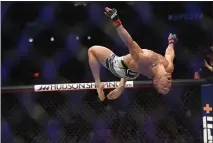  ?? ?? Michael Chandler does a back flip during UFC 274 at Footprint Center in Phoenix, Arizona on Saturday. Chandler won the fight.