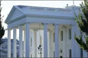  ?? SUSAN WALSH — THE ASSOCIATED PRESS ?? Someone works on the light fixture over the North Portico of the White House in Washington on Friday.