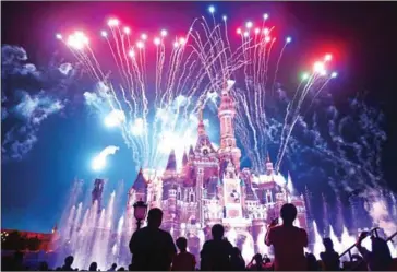  ?? AFP ?? Visitors watch fireworks exploding to mark the first anniversar­y of the opening of Shanghai Disneyland.