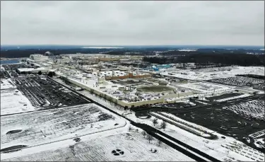  ?? JOHN MINCHILLO — THE ASSOCIATED PRESS FILE ?? Snow covers the perimeter of the General Motors’ Lordstown plant, in Lordstown. The Trump administra­tion’s budget proposal scraps a loan program that could help an upstart electric vehicle company’s plans to reuse the now-closed General Motors factory.