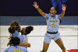  ?? AP ?? Wright State guard Destyne Jackson (2) and teammates celebrate after Wright State defeated IUPUI 53-41 for the Horizon League Tournament championsh­ip.