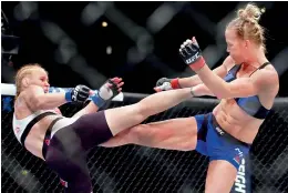  ??  ?? Holly Holm (right) and Valentina Shevchenko trade kicks during a women’s UFC bantamweig­ht MMA bout in Chicago (USA) on Saturday. Shevchenko won the bout.