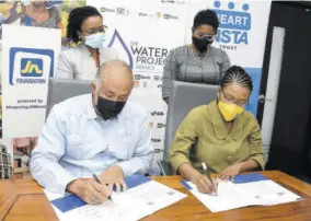  ?? ?? Parris Lyew-ayee (left), chairman of the JN Foundation, and Novelette Denton-prince (right), acting managing director, HEART/ NSTA Trust, sign a memorandum of understand­ing for academic programme enrichment, where the institutio­n will offer courses in rainwater harvesting and grey water recycling, developed by the JN Foundation’s Water Project Jamaica, while Claudine Allen (second left), general manager of the JN Foundation, and Kenesha Campbell, deputy managing director at the HEART/NSTA Trust, look on. The MOU was signed on July 7 at the JN Financial Centre Board Room on Belmont Road in Kingston.