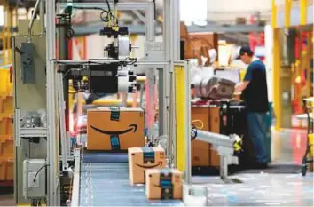  ?? AP ?? Packages go through the scanner at an Amazon fulfillmen­t centre in Baltimore. Amazon has come under fire from US President Donald Trump for its deals with the US Postal Service.