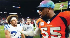  ?? JACK DEMPSEY - THE ASSOCIATED PRESS ?? Denver Broncos linebacker Bradley Chubb (55) and Indianapol­is Colts running back Phillip Lindsay (30) meet at mid field an NFL football game, Thursday, Oct. 6, 2022, in Denver.