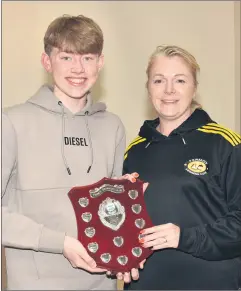  ?? ?? Fermoy Swimming Club Swimmer of the Year 2022/23 Zach DanielsHow­ard is presented with his award by coach Joann Baker.