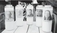  ?? KARL MERTON FERRON/BALTIMORE SUN ?? Candles honoring Gerald Fischman, Rob Hiassen, John McNamara, Rebecca Smith and Wendi Winters flicker as the sun sets during a candleligh­t vigil at Annapolis Mall for five Capital Gazette employees slain during a shooting spree in their newsroom.