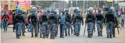 ??  ?? ON STANDBY: Riot police out in force after racial tensions flared up in Coligny