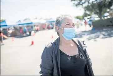  ?? PHOTOS DAI SUGANO — STAFF PHOTOGRAPH­ER ?? Rosa Valencia of San Jose relies on Catholic Charities of Santa Clara County’s food distributi­on service at St. Lucy Catholic Parish to supplement food stamps. It helps feed a household that includes her three children and a grandchild.