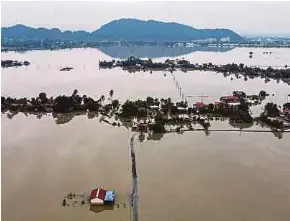  ?? AFP PIC ?? An aerial view of homes surrounded by floodwater­s in Kangar last Friday.