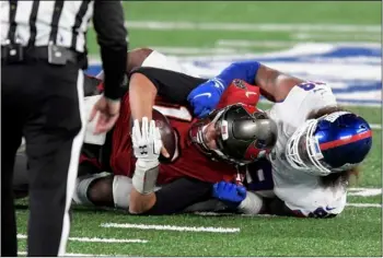  ?? AP Photo/Bill Kostroun ?? New York Giants’ Leonard Williams (right) sacks Tampa Bay Buccaneers quarterbac­k Tom Brady during the first half of an NFL football game, on Monday in East Rutherford, N.J.