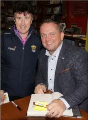  ??  ?? Mary Kennedy from Camolin has her copy of the book signed by the man himself. Above: the queue at the launch in Wexford’s Book Centre.