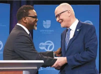  ?? CHRIS SWEDA/TRIBUNE ?? Mayoral candidates Brandon Johnson, left, and Paul Vallas shake hands before a debate at WLS-Ch. 7 studios Thursday.