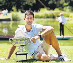  ?? PHOTO: GETTY IMAGES ?? Spoils of a champion . . . Novak Djokovic relaxes in Melbourne yesterday with the Norman Brookes Challenge Cup, which he won after beating Rafael Nadal in the men’s singles final at the Australian Open in Melbourne on Sunday night.