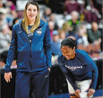  ?? SEAN D. ELLIOT/THE DAY ?? UConn’s Katie Lou Samuelson, left, chats with teammate Crystal Dangerfiel­d prior to the Huskies’ game against East Carolina in the AAC tournament on March 9. Samuelson, who missed the tournament with back spasms, will return on today when the second-seeded Huskies host No. 15 Towson in the first round of the NCAA tournament’s Albany Regional at Gampel Pavilion in Storrs.