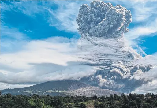  ?? ANTO SEMBIRING AFP VIA GETTY IMAGES ?? Mount Sinabung spews thick ash and smoke as high as 5,000 metres into the sky in Karo, North Sumatra, Indonesia, on Monday.