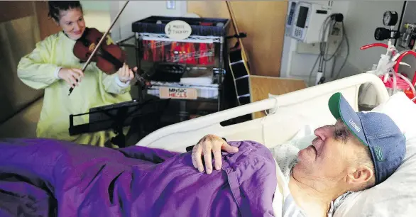  ?? PHOTOS: NICK PROCAYLO ?? Music therapist Lucy Thomas plays for palliative care patient George Frederick, 91, at St. Paul’s Hospital in Vancouver.