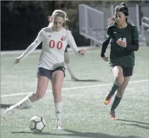  ?? Nikolas Samuels/The Signal ?? (Above) Santa Clarita Christian’s Kalona Marr (00) pulls back to kick the ball around a Guidance Charter defender during a game on Monday at College of the Canyons. (Below) Santa Clarita Christian’s Siloam Brenner (4) does a move to escape a defender...