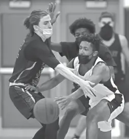  ?? MICHAEL CHOW/THE REPUBLIC ?? Brophy Prep's Miles Nash passes around Valley Vista's Clayton Werner during a game in Phoenix on Tuesday.