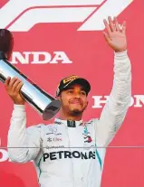  ?? Reuters ?? Lewis Hamilton celebrates on the podium after his win at the Japanese Grand Prix yesterday.