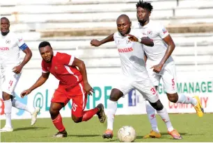  ??  ?? Isaac Loute (31) and Pape Ousmane of Rangers are being challenged to the ball by Abubakar Umar of Wikki Tourists during a league match