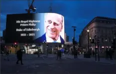  ?? Alberto Pezzali/Associated Press ?? A tribute to Britain’s Prince Philip is projected onto a large screen at Piccadilly Circus in London on Friday.