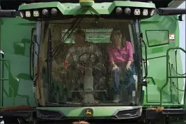  ?? CHARLIE NEIBERGALL — THE ASSOCIATED PRESS FILE ?? Republican presidenti­al candidate and former U.N. Ambassador Nikki Haley rides in a combine with farmer Dennis Campbell, left, on Friday in Grand Mound, Iowa.