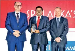  ??  ?? Commercial Bank’s CEO designate S. Renganatha­n (centre) with the Euromoney award.