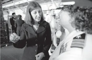  ?? STEVE HELBER/AP ?? Rep. Elaine Luria, D-Va., speaks to a naval officer July 15 aboard the USS Kearsarge at Naval Station Norfolk in Virginia. Luria, a Navy veteran, defeated incumbent Republican Scott Taylor, a former SEAL, for office in 2018 and in 2020.