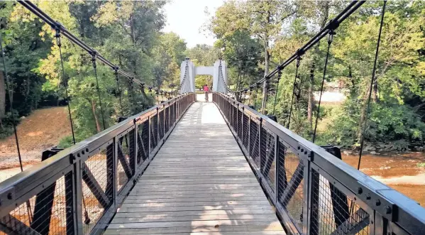  ?? PHOTOS PROVIDED BY THE RAILS-TO-TRAILS CONSERVANC­Y ?? Ohio’s Alum Creek Greenway Trail: South of Wolfe Park, cyclists will pass over a bridge built in 1922.