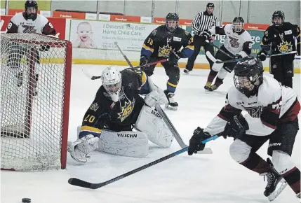  ?? CLIFFORD SKARSTEDT EXAMINER ?? Peterborou­gh Rico’s Foods Major Midget AAA Petes’ Clayton Shaughness­y skates after a loose puck against Brampton 45s’ goalie Hayden Williamson on the opening day of the Steve Richey Midget Tournament of Champions on Thursday at the Evinrude Centre.