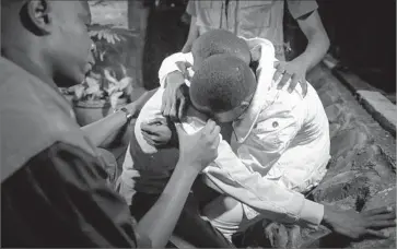  ?? Dai Kurokawa European Pressphoto Agency ?? A RELATIVE of one of those killed at a hotel in Mandera, Kenya, is comforted after the bodies of victims arrived at a Nairobi mortuary. Islamic extremists reportedly used explosives and guns in the attack.